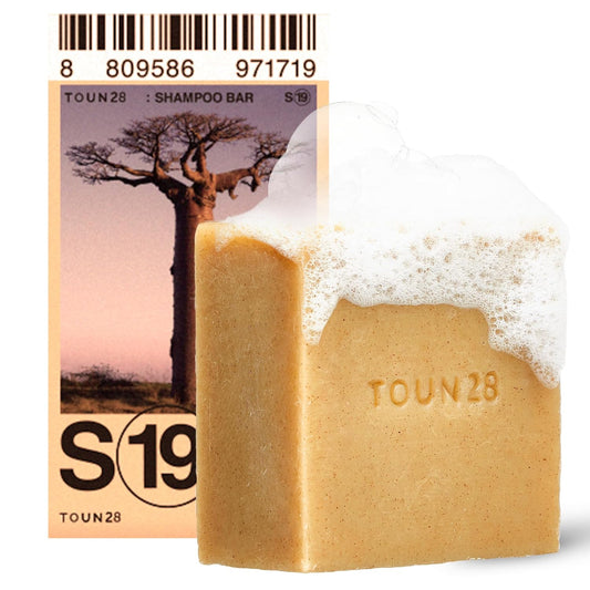 Bar of soap with 'TOUN28' branding and packaging featuring a tree design.