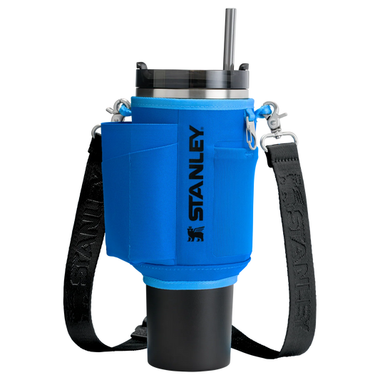 Blue and black Stanley cup holder with a black strap on a white background